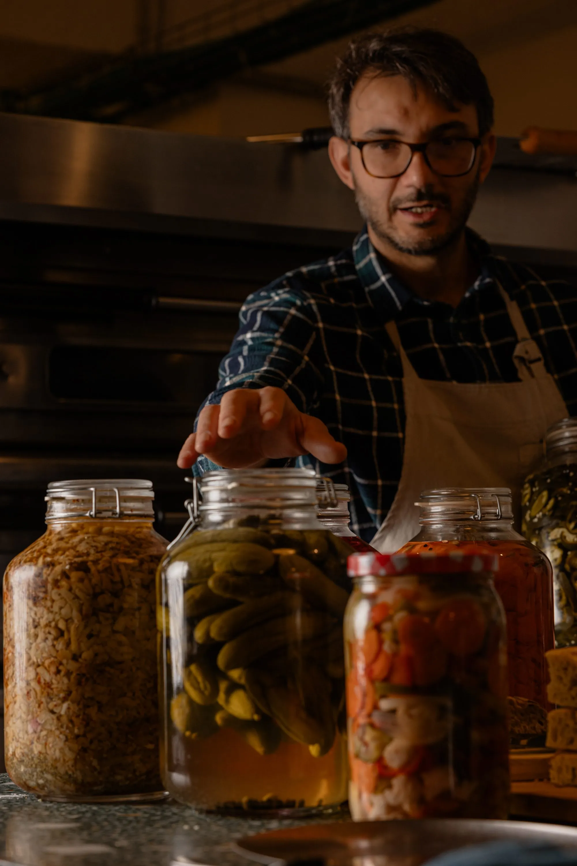 Vincenzo beside his ferment and preserve jars